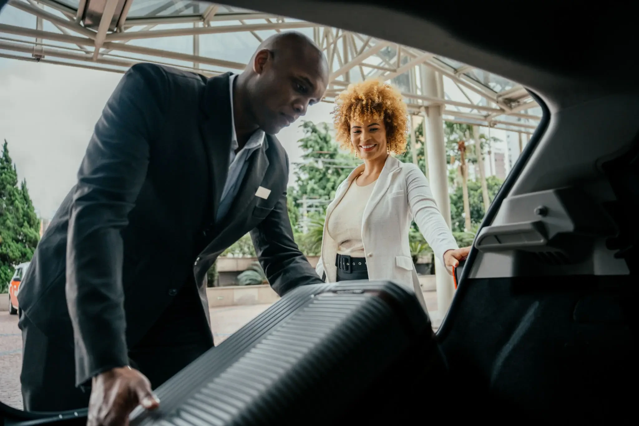 FC Luxs chauffeur loading luggage for a client